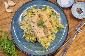 Salmon fillet on ribbon pasta in a garlic cream sauce
