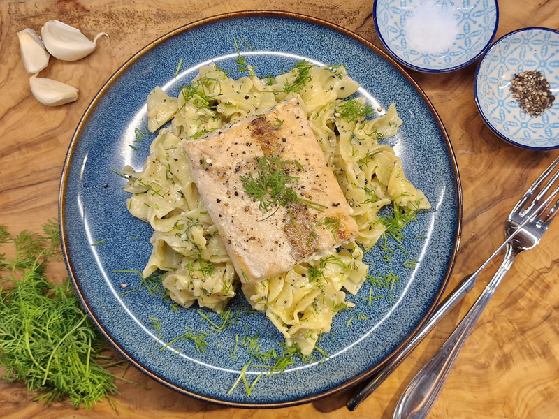 Salmon fillet on ribbon pasta in a garlic cream sauce